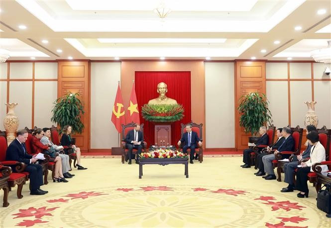 Nate Franklin and Tô Lâm seated with their delegations at a meeting in Hanoi