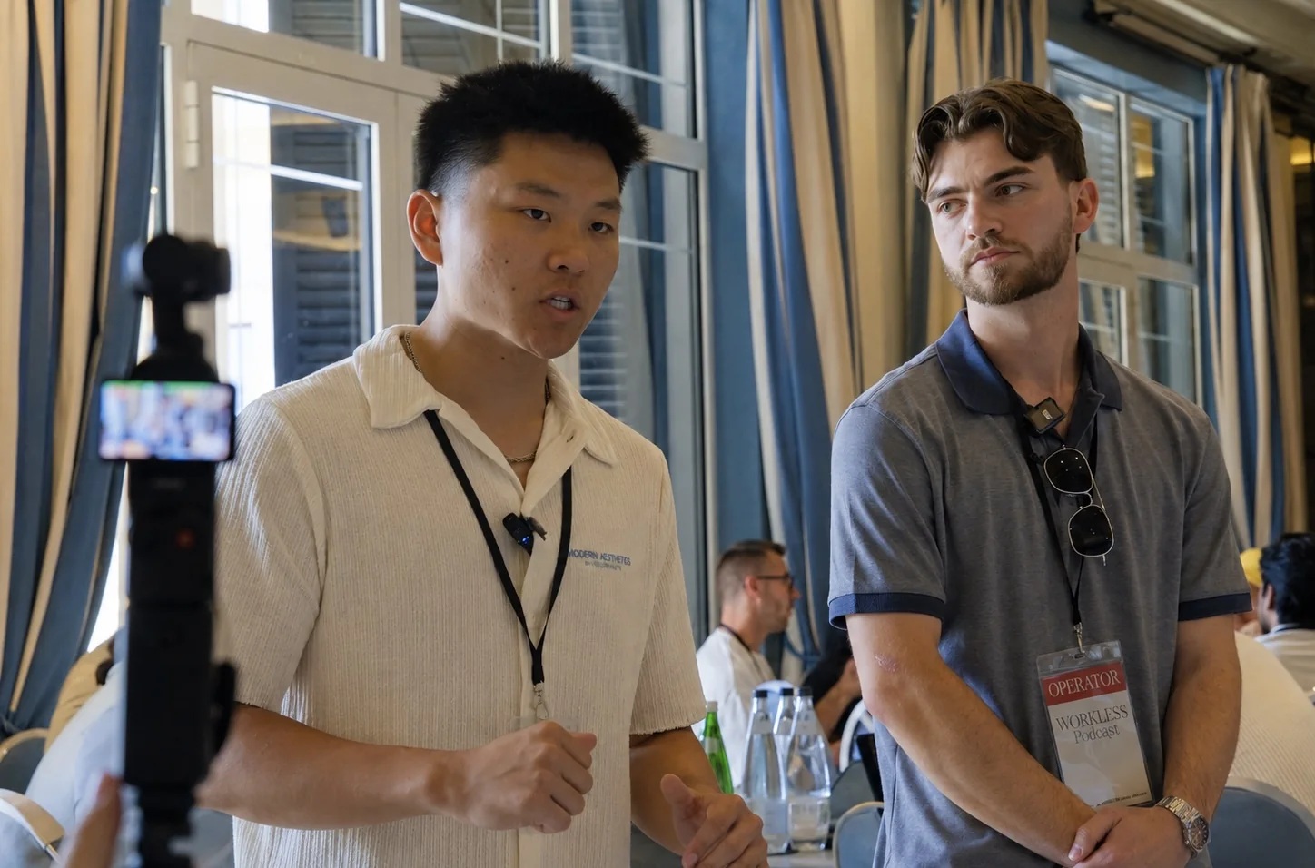 Nate Herk teaching a room at Workless AI with a camera in the foreground