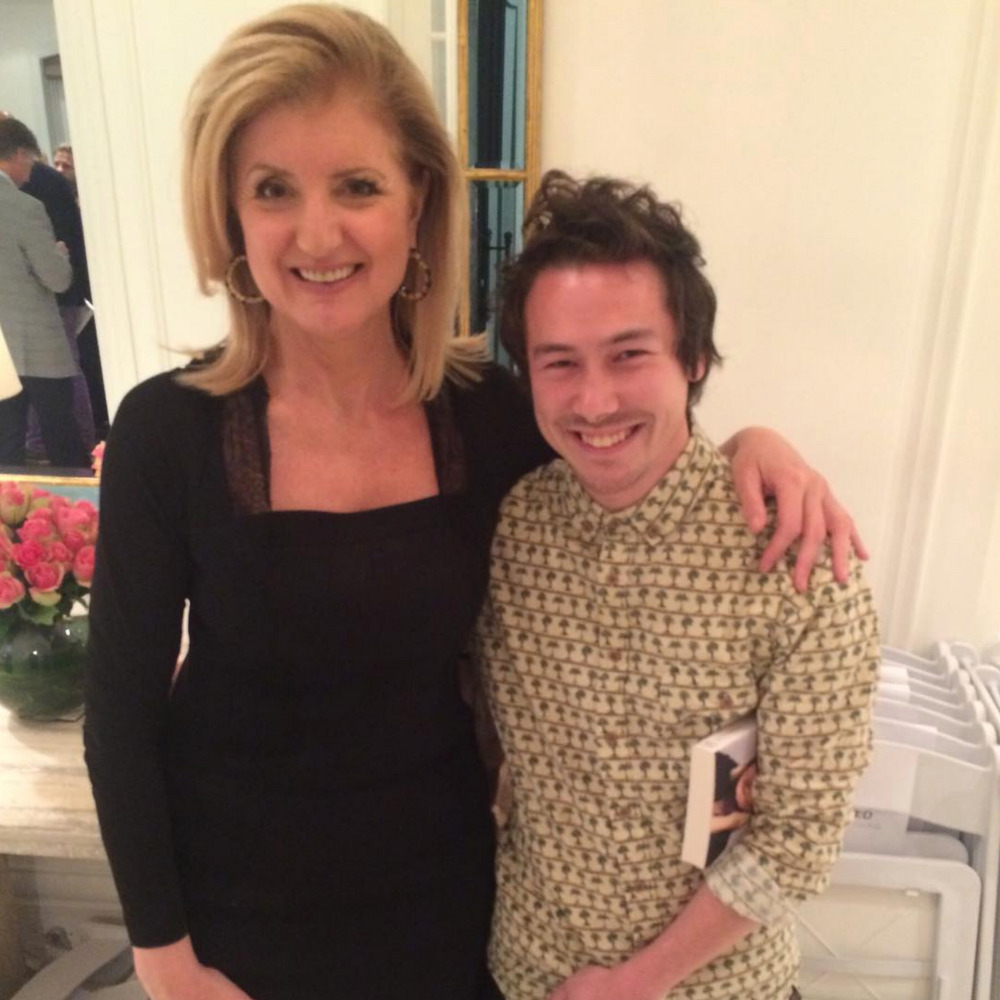 Arianna Huffington with Nathan Chan, who is holding a book.