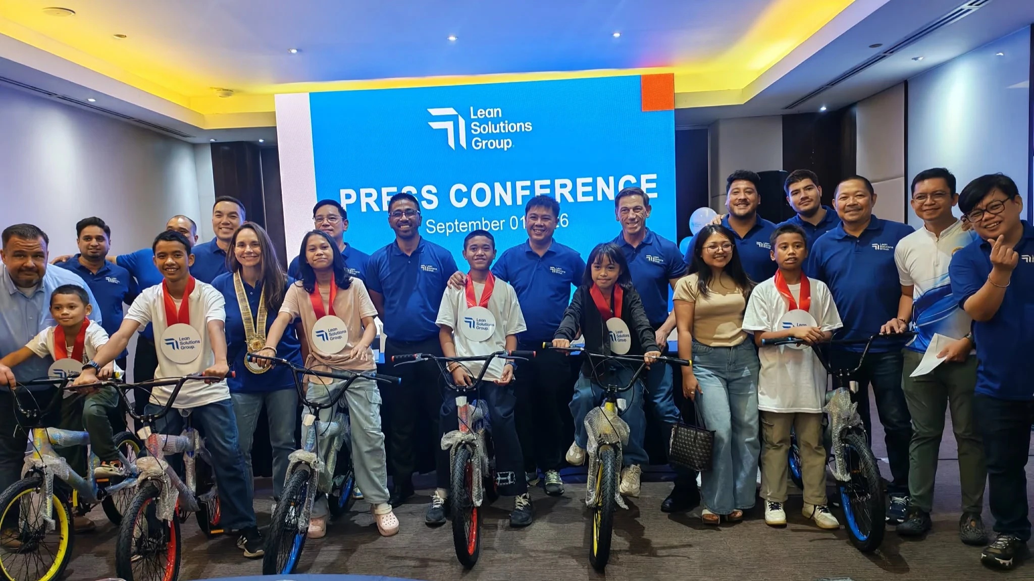 SupportZebra and Lean Solutions Group representatives with young people and bicycles at a Cagayan de Oro press event.