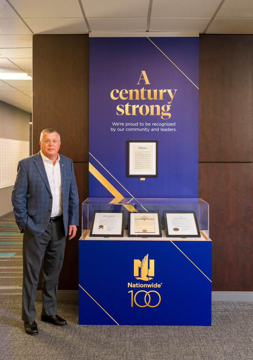 Nationwide CEO Kirt Walker beside a display of centennial proclamations