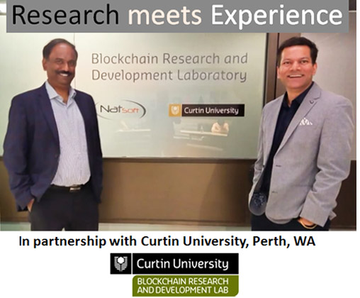 Two representatives beside signage for the Natsoft and Curtin University Blockchain Research and Development Laboratory