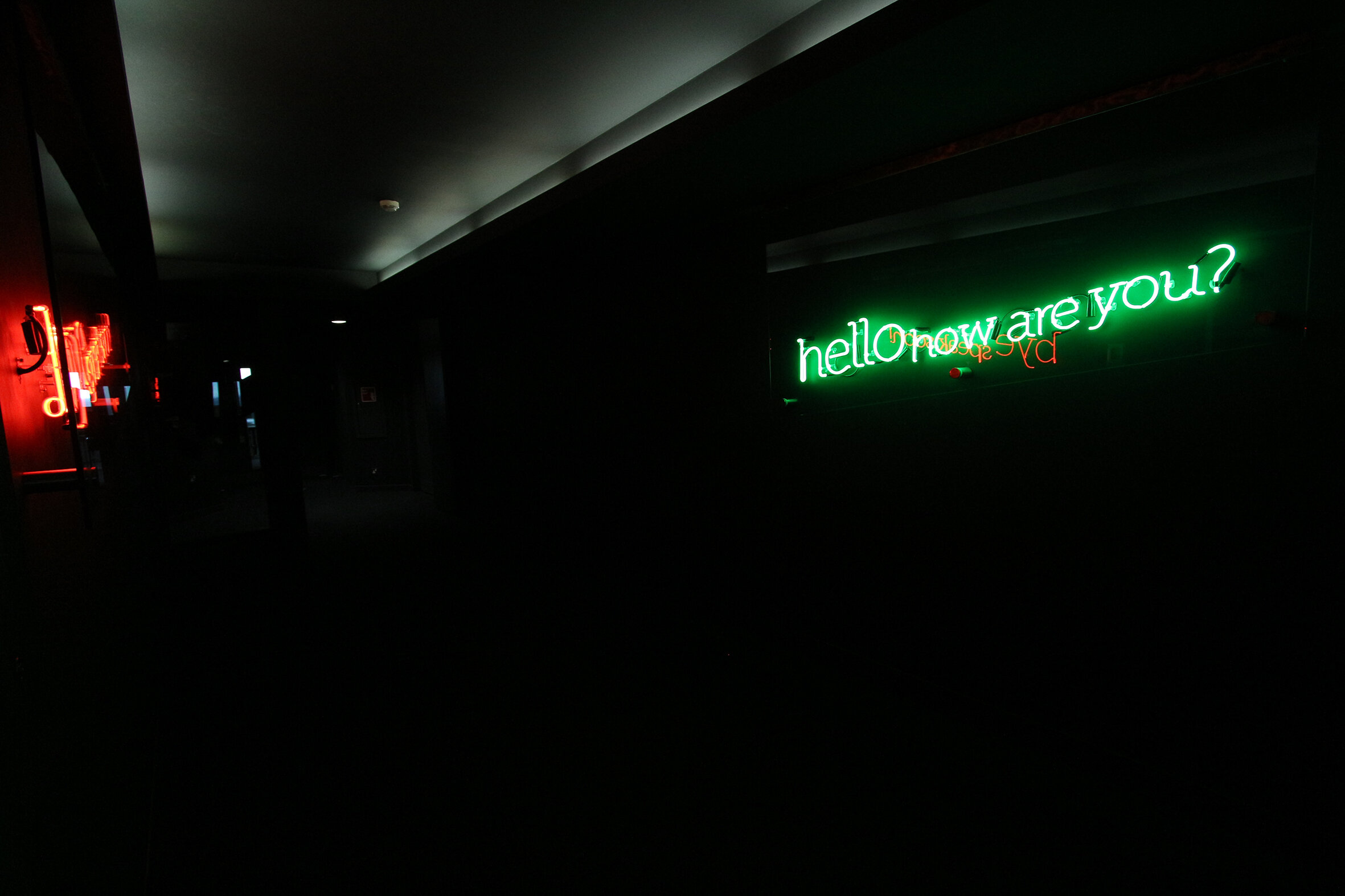 Green neon lettering reading hello how are you in Natterbox’s former Croydon office