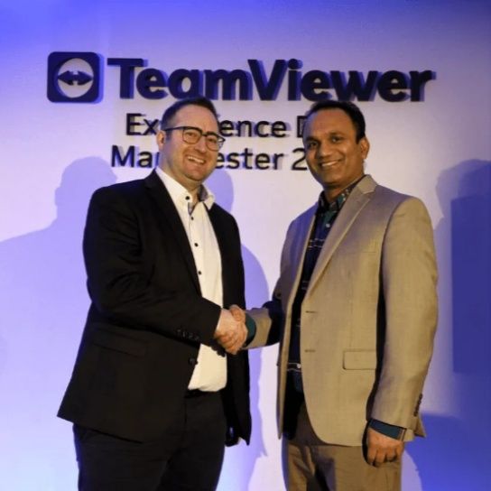 Navdeep Singla, right, shaking hands with a TeamViewer executive at a company event