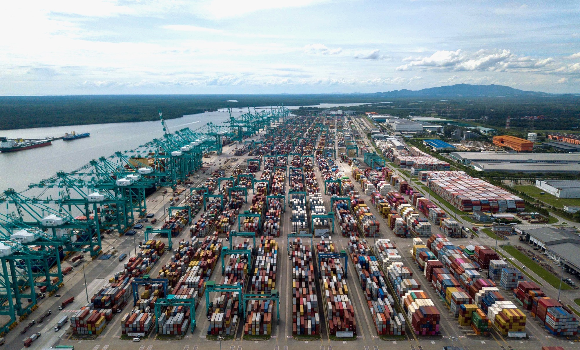 Aerial view of container stacks and quay cranes at Port of Tanjung Pelepas in Malaysia