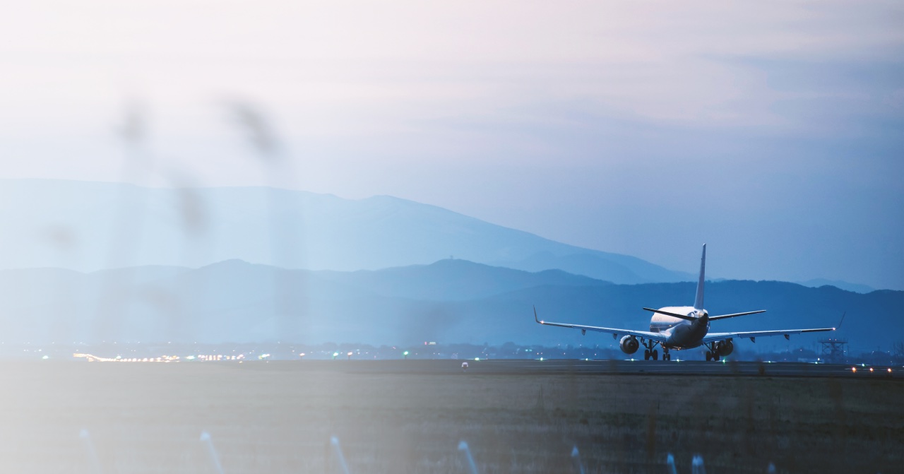 Passenger aircraft on a runway with blue mountains behind it
