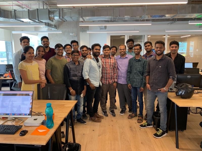 Navtech employees gathered between desks in an open-plan office