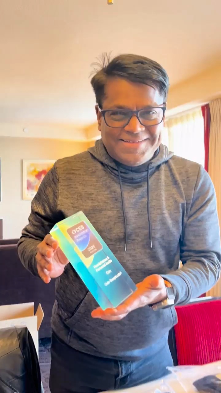 NB Patil smiling while holding Ozlo’s CES 2025 Innovation Award
