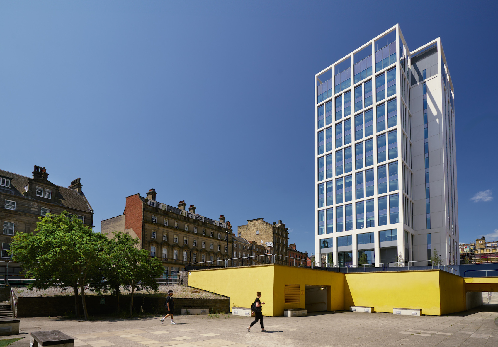 Bank House's glass and concrete façade rises above Newcastle's older streets