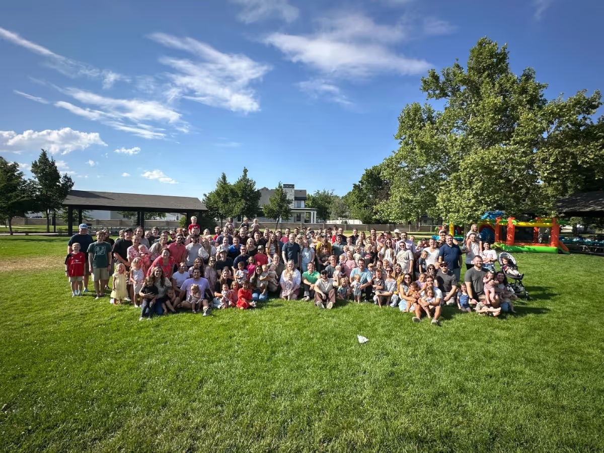 A group pictured outdoors on a green field in Nectar’s company photo gallery