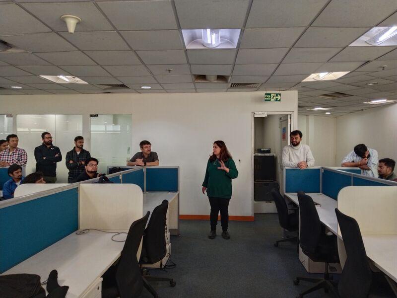 Neetu Seth addressing NITS colleagues among the desks at the Gurgaon office