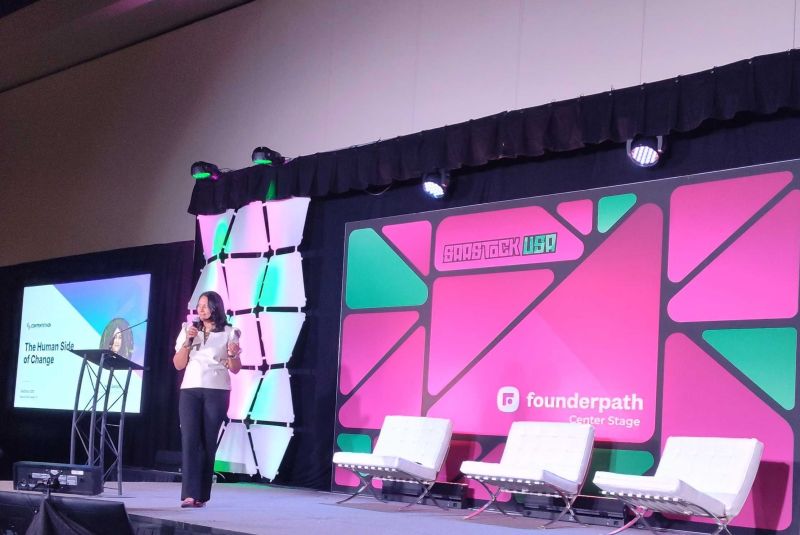 Neha Sampat on stage at SaaStock USA, presenting The Human Side of Change