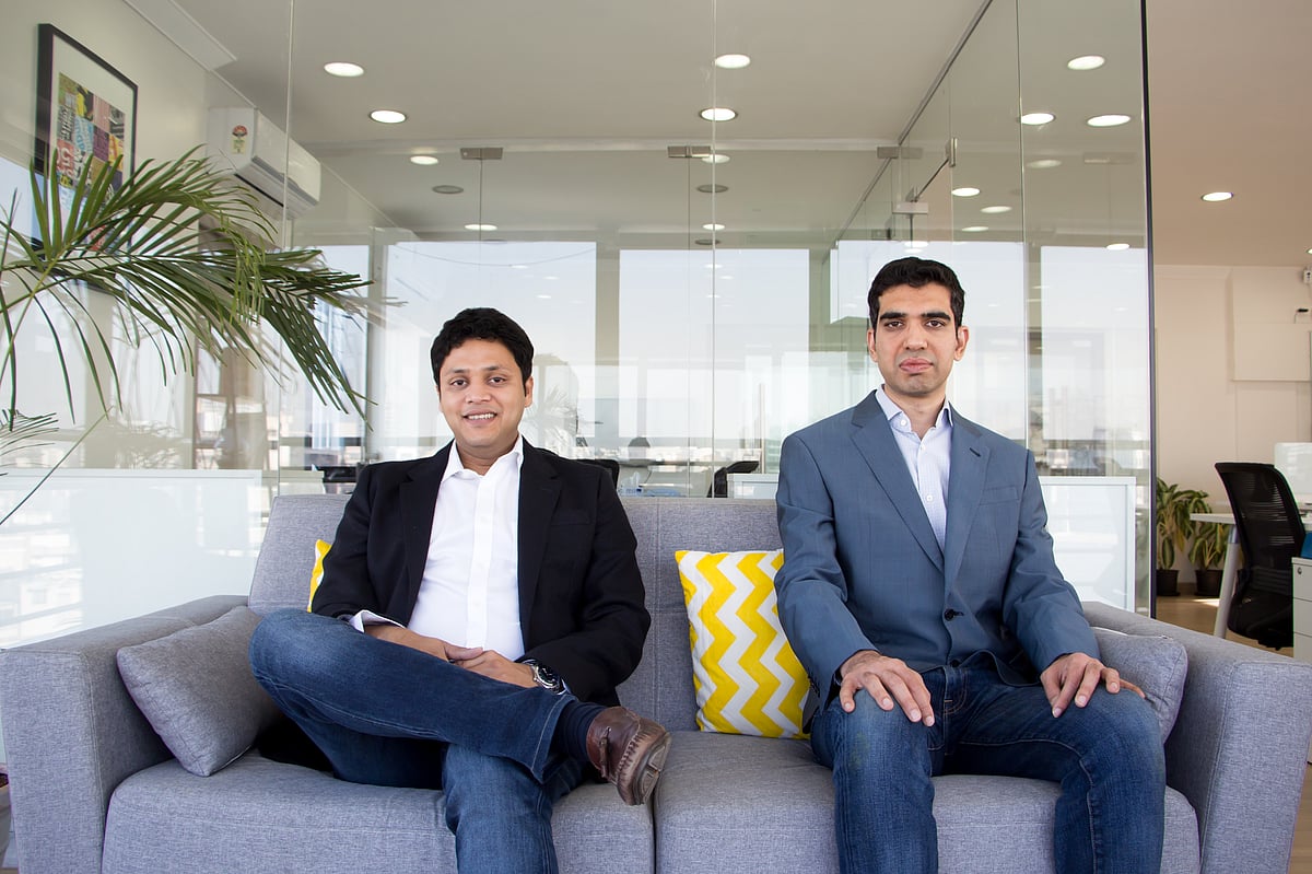 Drip Capital co-founders Pushkar Mukewar, left, and Neil Kothari, right, seated in an office