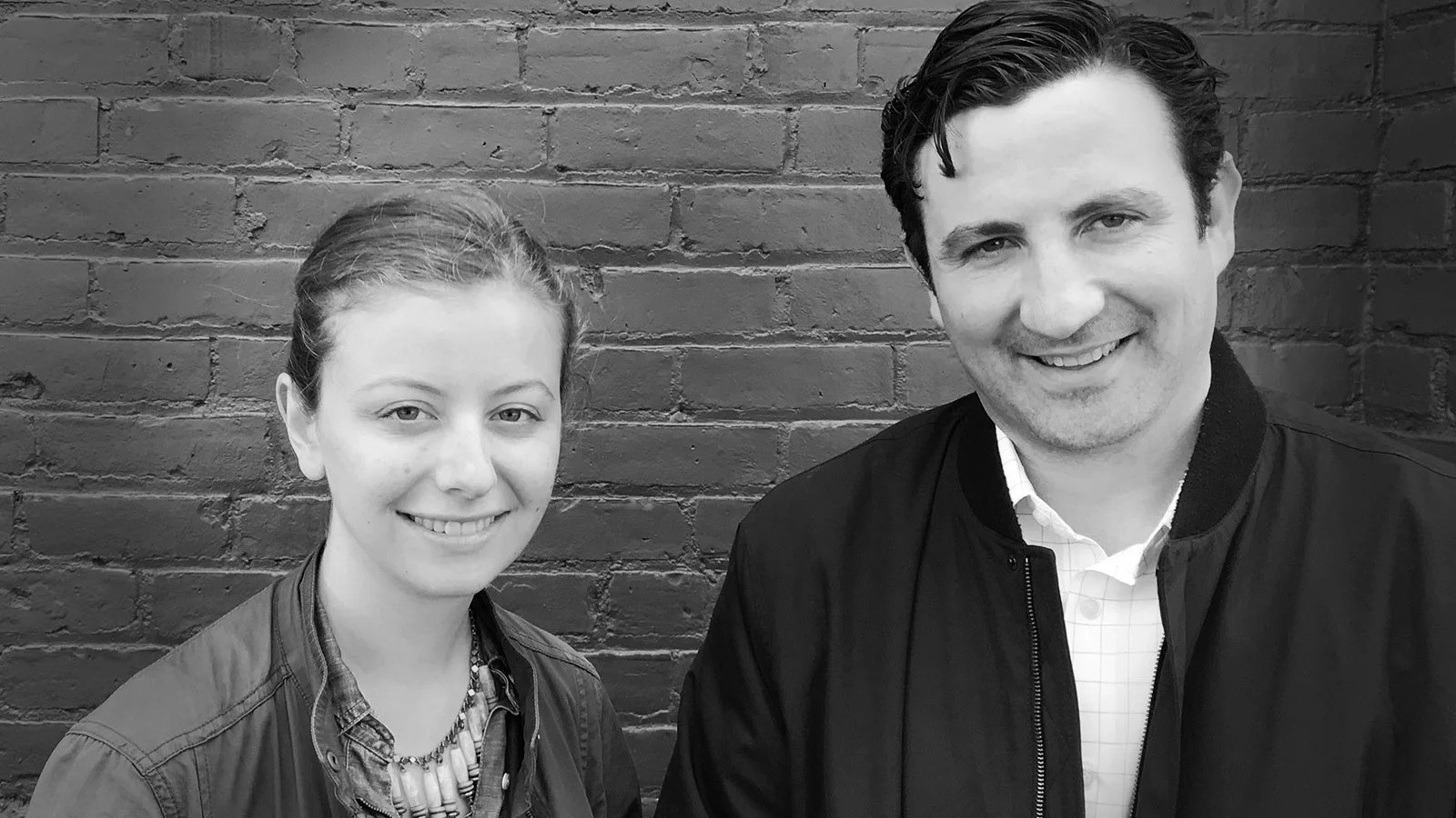 Nell Meosky Luo, left, and cofounder Dan Toffling standing beside a brick wall