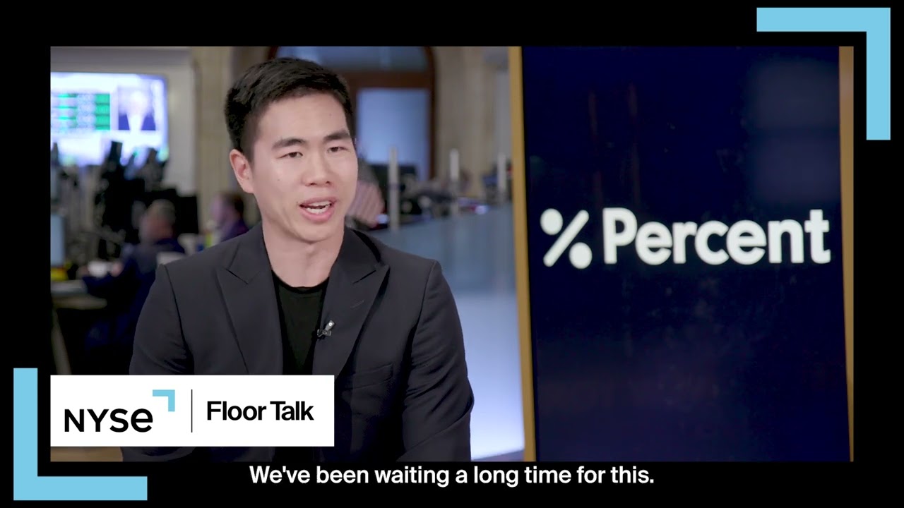 Nelson Chu speaking on NYSE Floor Talk beside a Percent screen