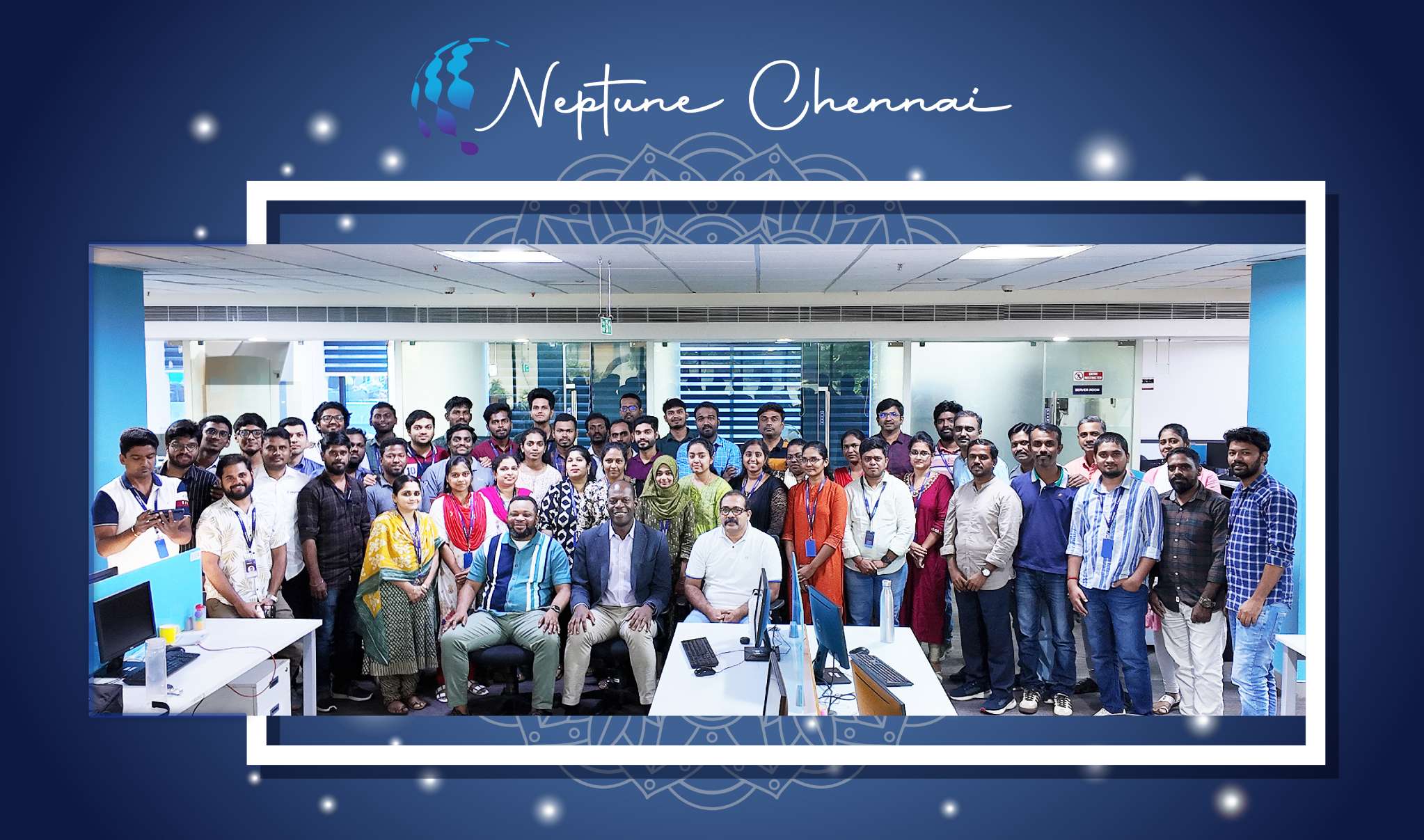 Neptune’s Chennai staff gathered between desks in the company office
