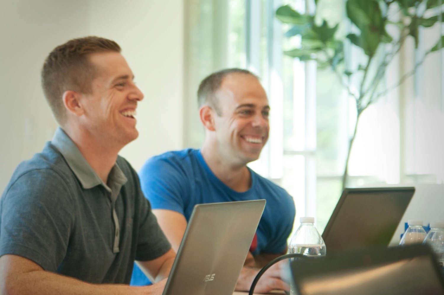 Two Netrush team members smiling during a meeting
