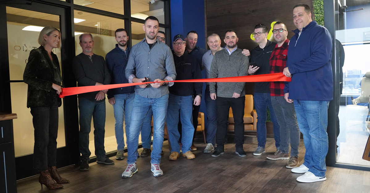 Nettxio colleagues cutting the ribbon at their Naperville office