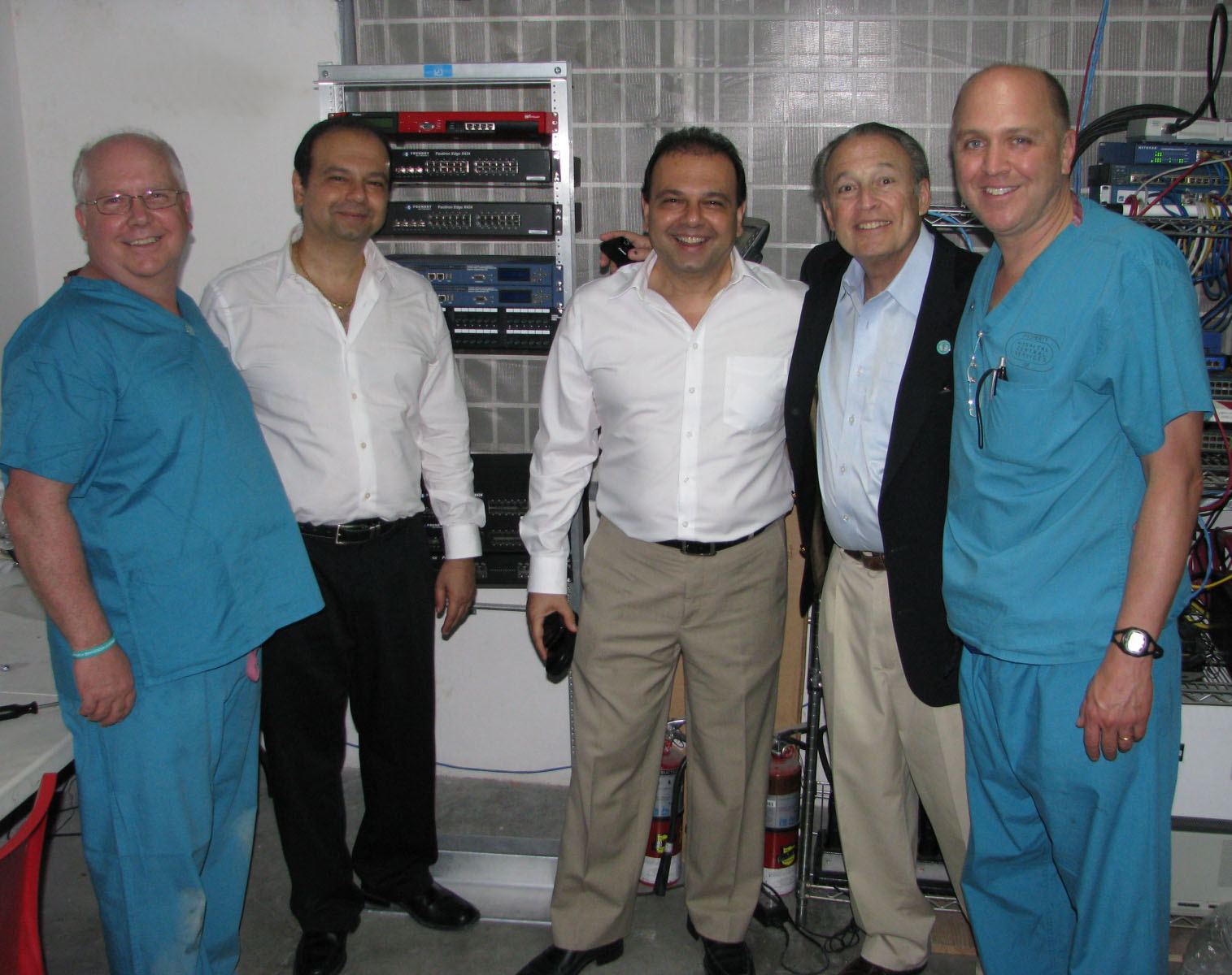 Project Medishare representatives standing beside network electronics donated by NCA in Haiti