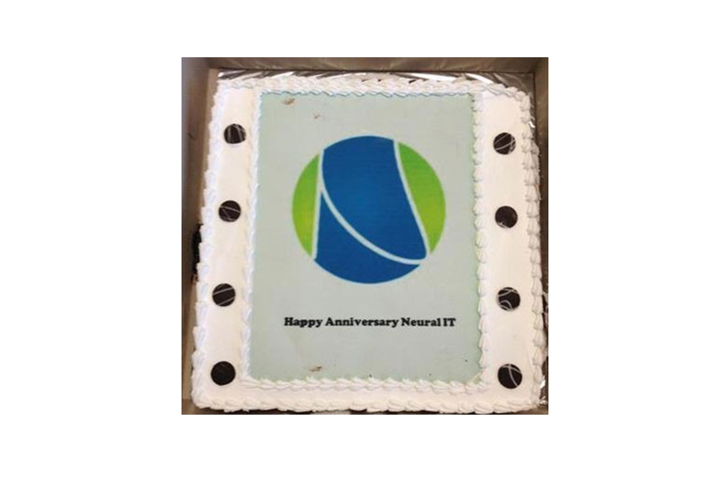 Cake photographed for Neural IT’s ninth anniversary, decorated with its blue and green emblem