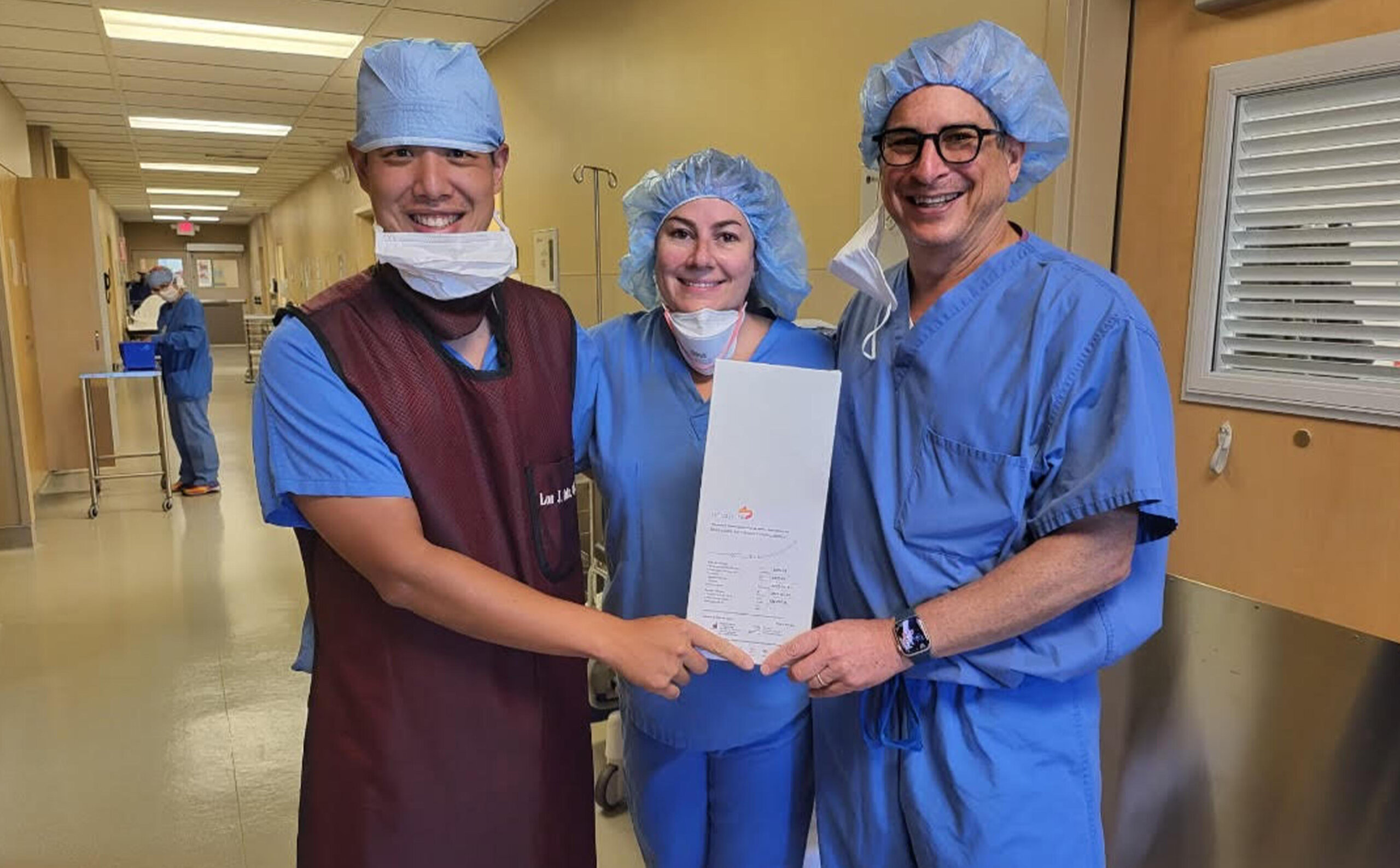 Clinical team photographed after an early Neuspera implant procedure