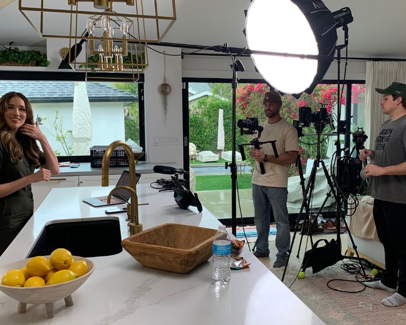 Donut Studios production crew filming in a kitchen with a camera rig and studio lighting