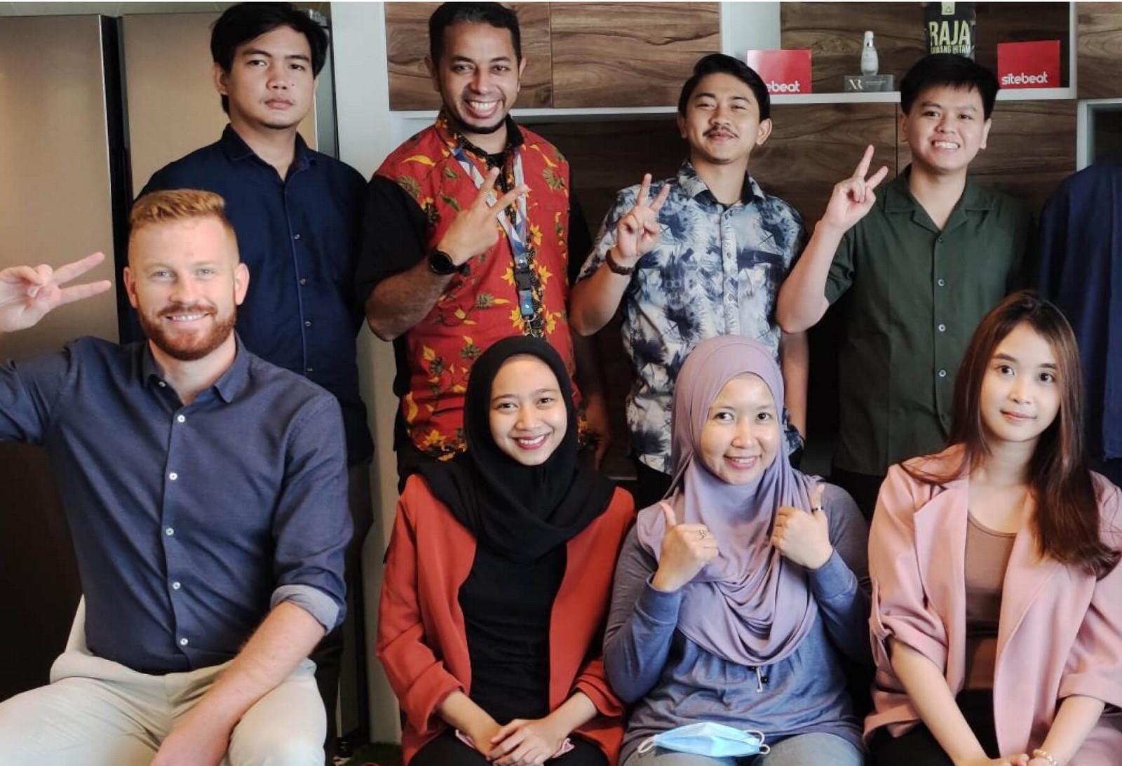 Newfold team members posing together in an office
