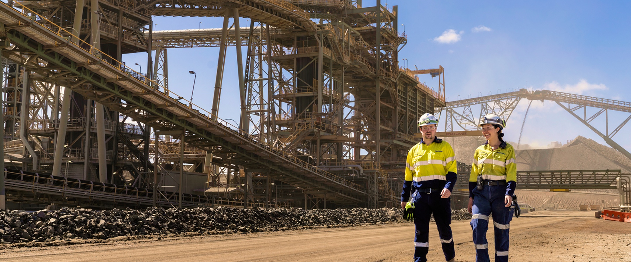 Two workers beside the processing infrastructure at Newmont’s Boddington operation