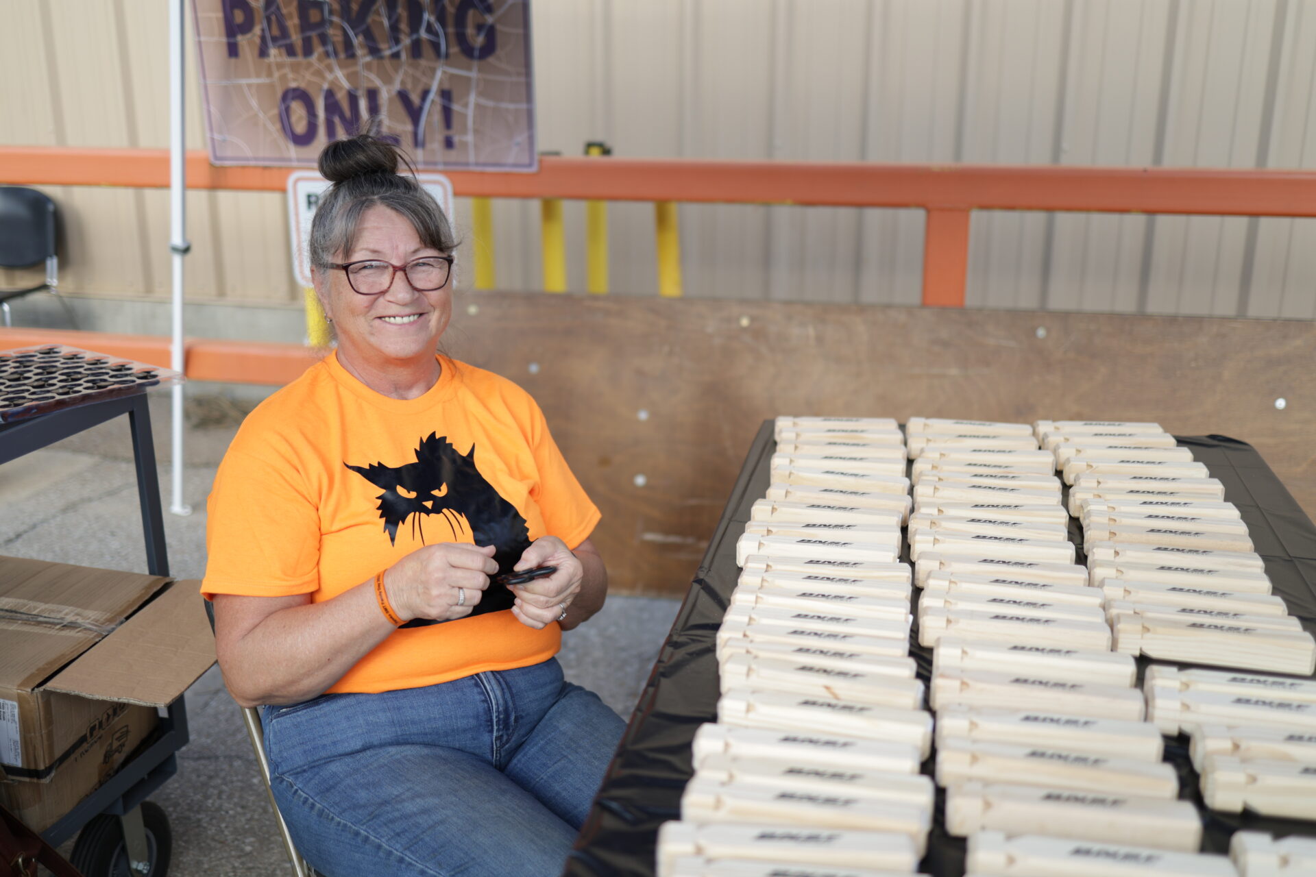 A worker prepares rows of BNSF-branded items at a Topeka family event photographed by News Link