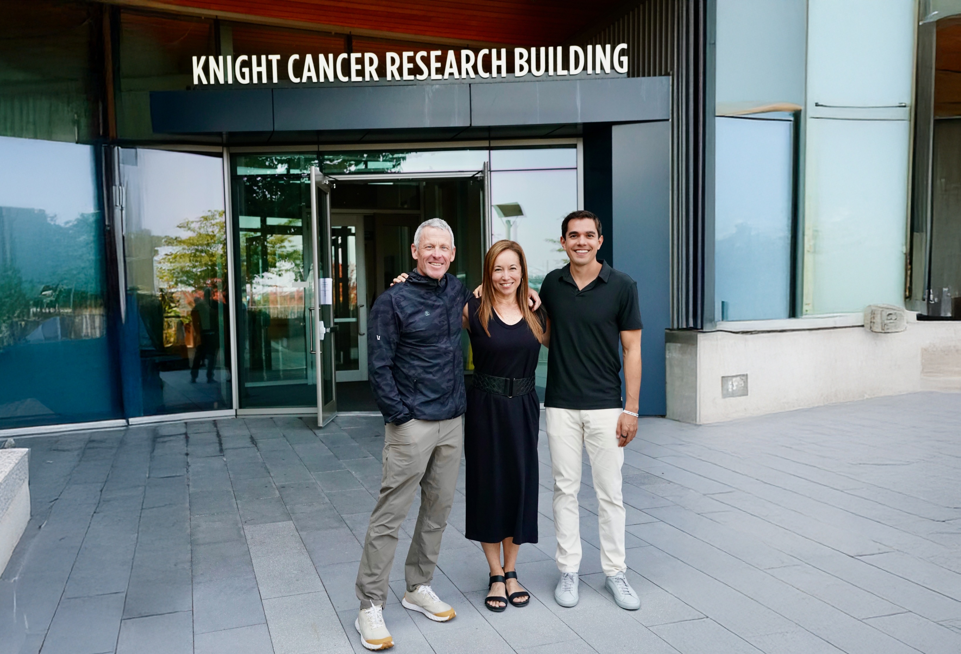Lance Armstrong, Mel Strong and Jordan Pascasio outside the Knight Cancer Research Building