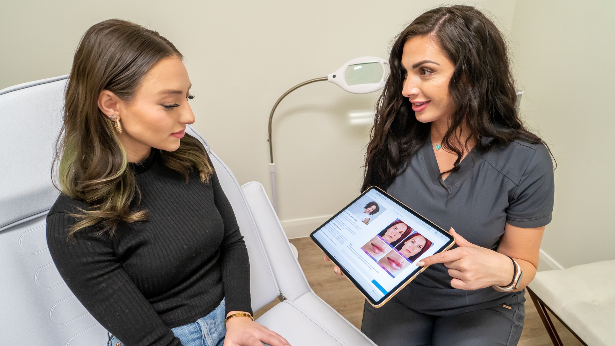 A practitioner uses TouchMD on a tablet to explain treatment images to a patient