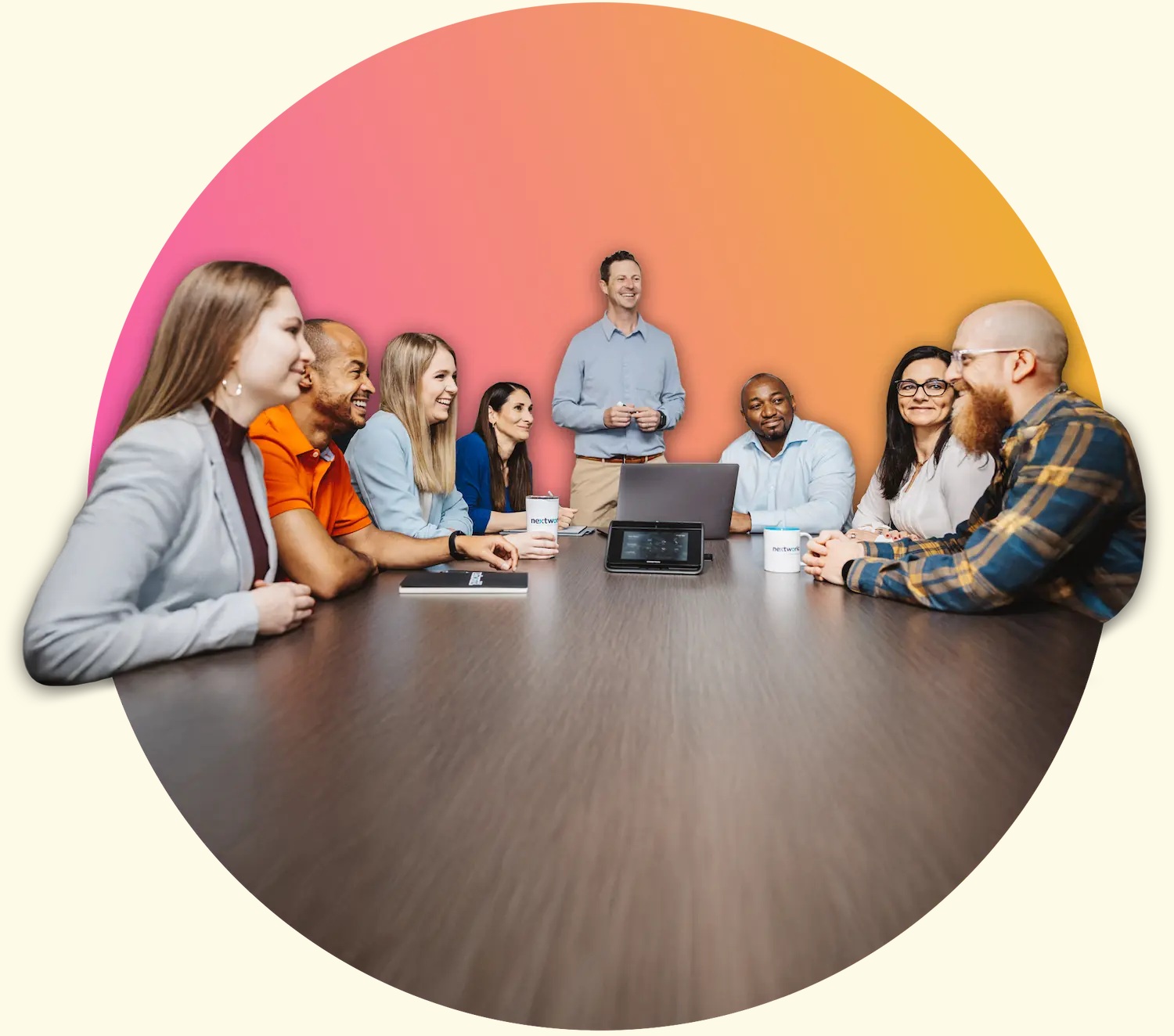 Nextworld coworkers gathered around a conference table