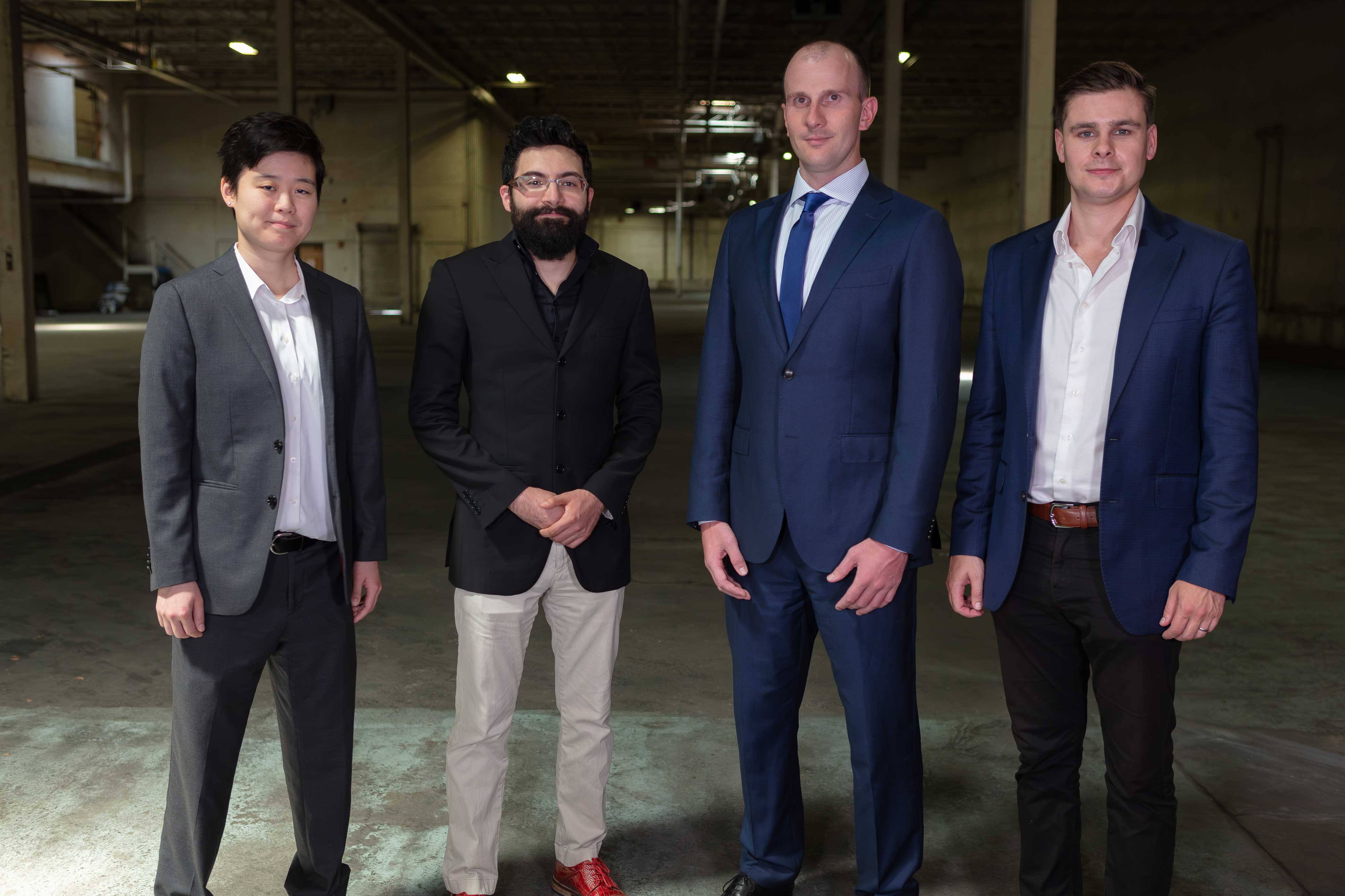 Phoenix Tailings founders Michelle Chao, Tomás Villalón, Nicholas Myers, and Anthony Balladon standing together in an industrial space