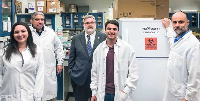 Nicholas Nicolaides in a Saint Joseph's University laboratory with students, Michael McCann, and Luigi Grasso