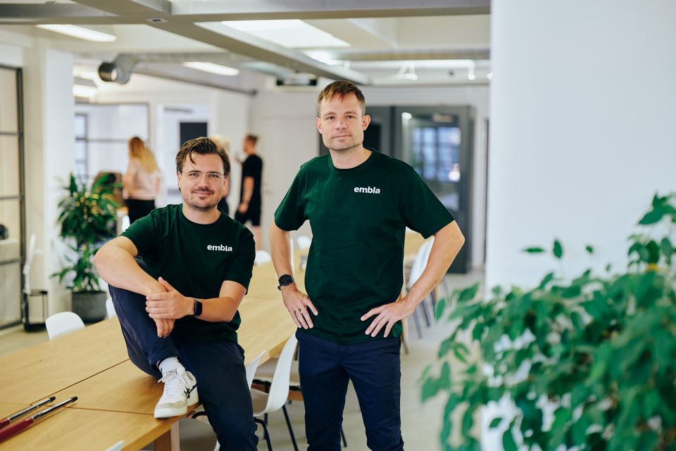 Embla co-founders Laust Axelsen and Nicholas Syhler standing together in their office