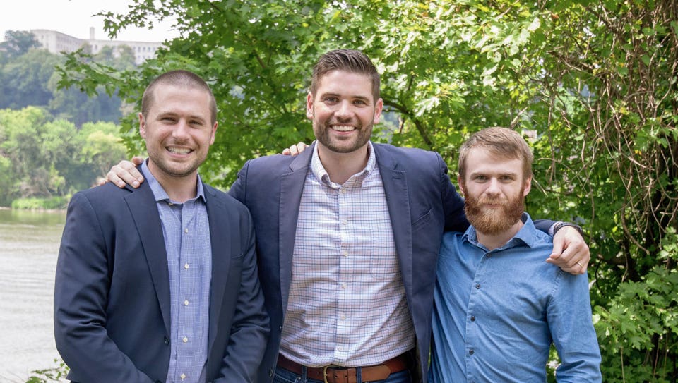 Nick Bartel, Hayden Cardiff, and Andrew Russell standing together outdoors