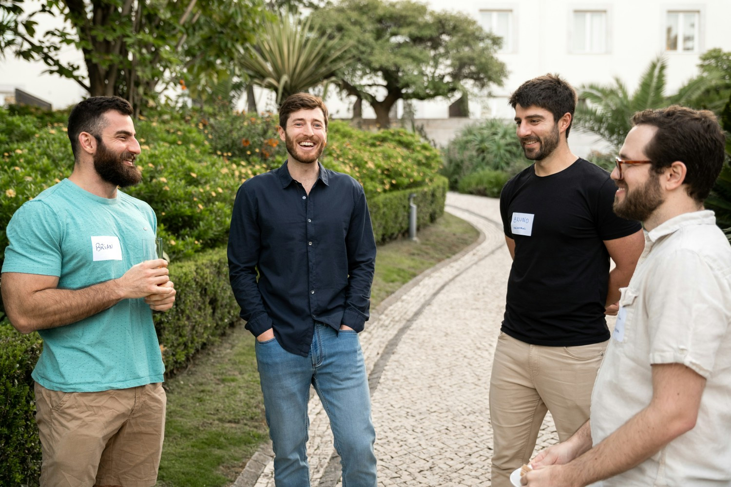 Nick Baum, second from left, chatting outdoors with Tremendous engineers