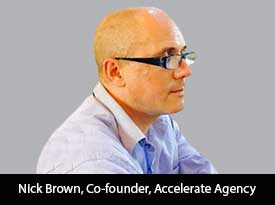 Archival press photograph of Nick Brown in glasses and a light blue shirt