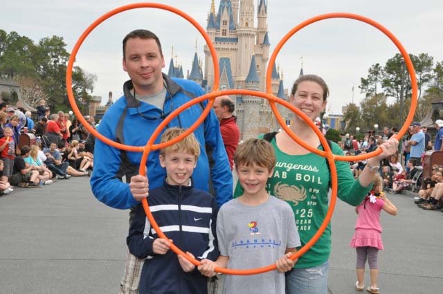 Nick Iwig with his family holding orange hoops on a published family vacation photo