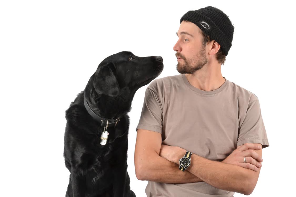 Nick Martin and his black Labrador Norman looking at one another