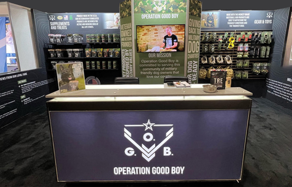 Operation Good Boy trade-show display with branded counter, shelving and wall graphics