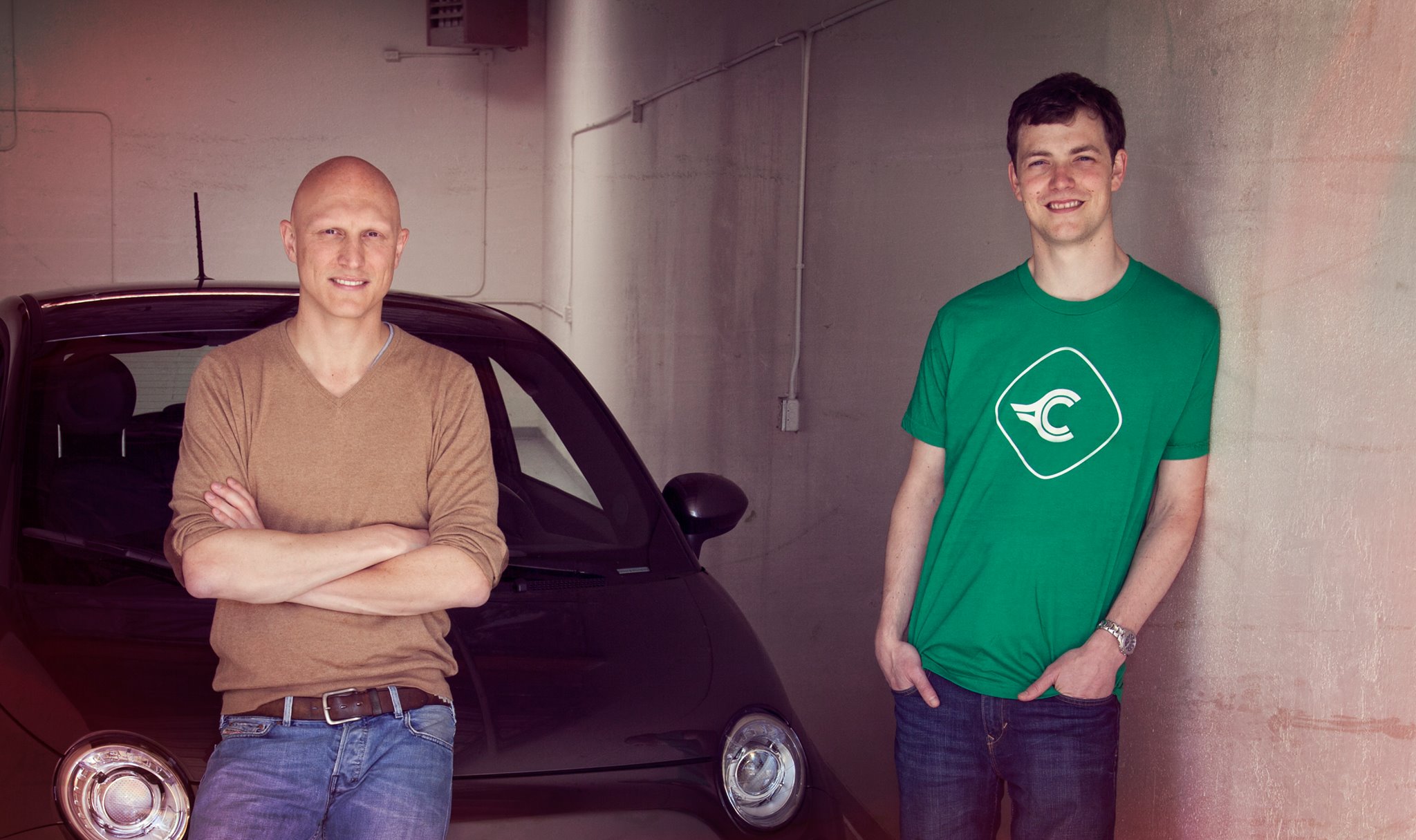 Nicholas Hinrichsen on the left and Chris Coleman on the right, standing beside a car