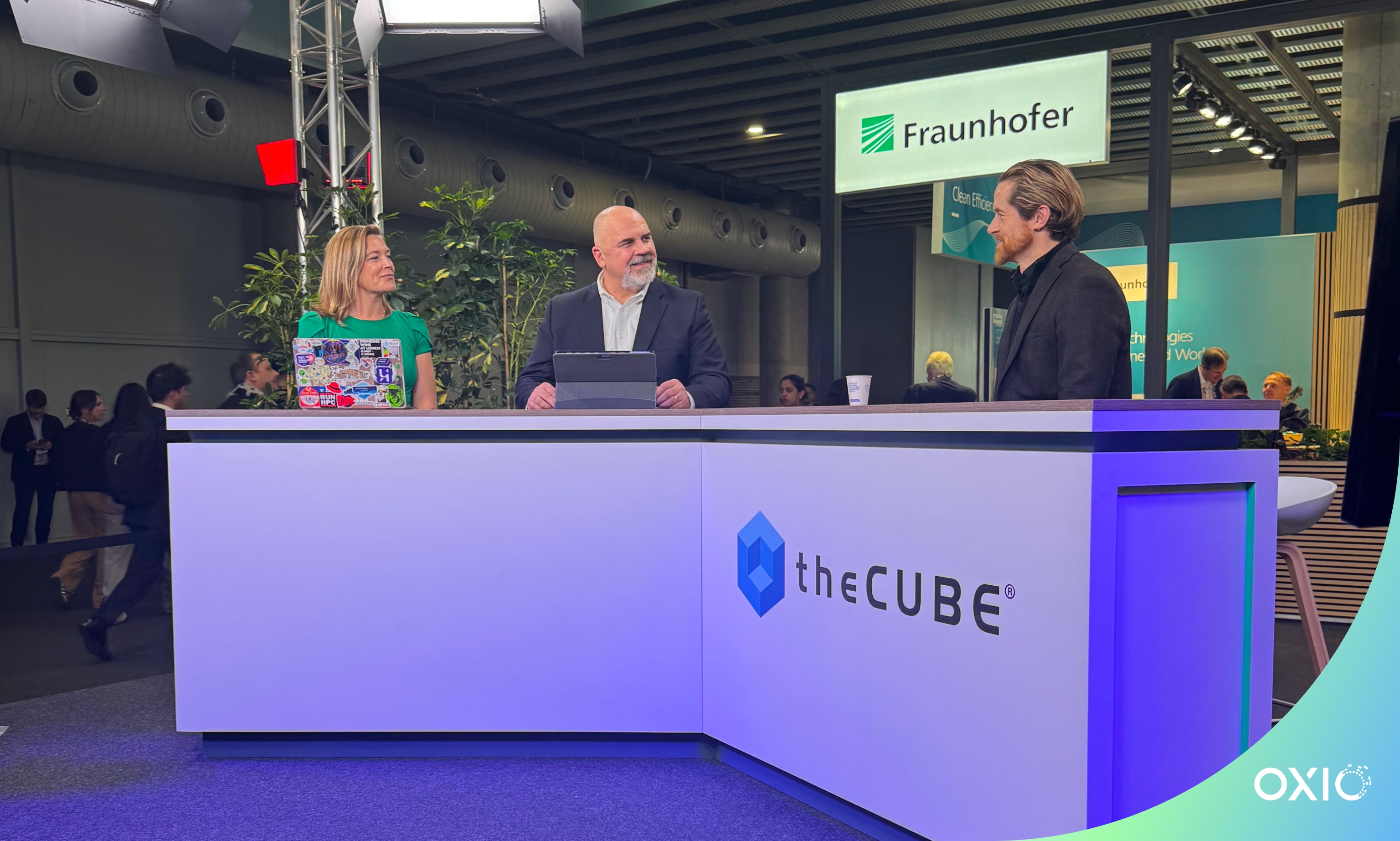Nicolas Girard at right, talking with Savannah Peterson and Bob Laliberte at theCUBE’s desk during MWC Barcelona 2025
