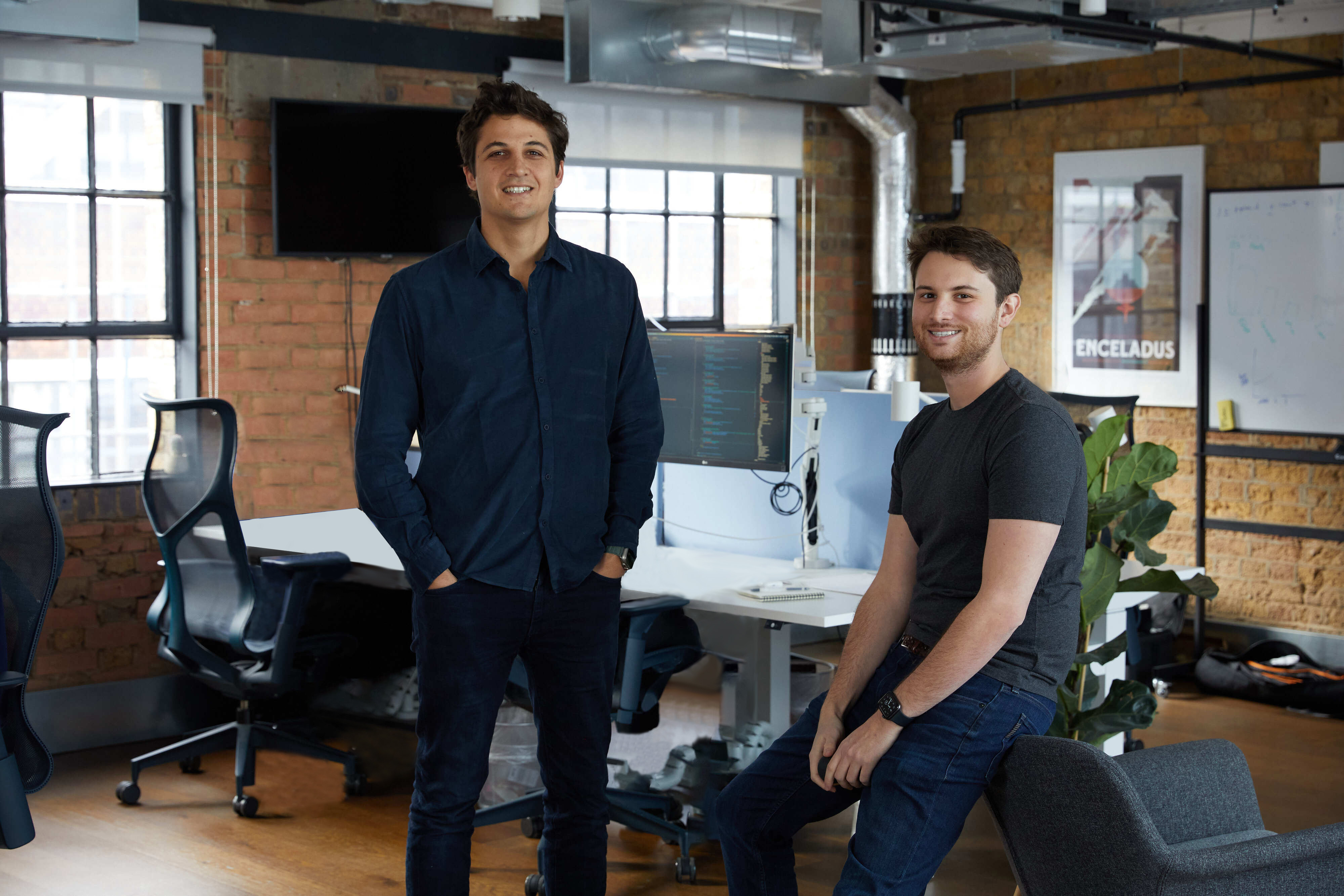 Nicolas Sharp standing beside co-founder Alex Christie in an office