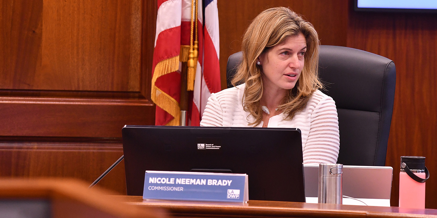 Nicole Neeman Brady seated at the Los Angeles Board of Water and Power Commissioners desk, with her nameplate in front of her