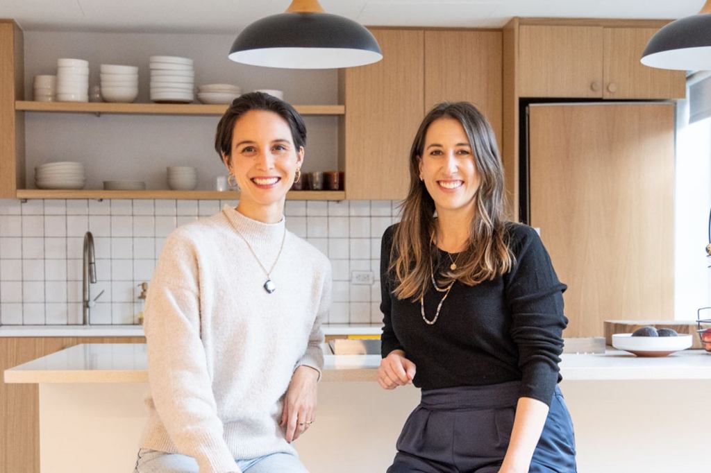 Nicole Centeno and Elise Densborn standing together in a bright kitchen