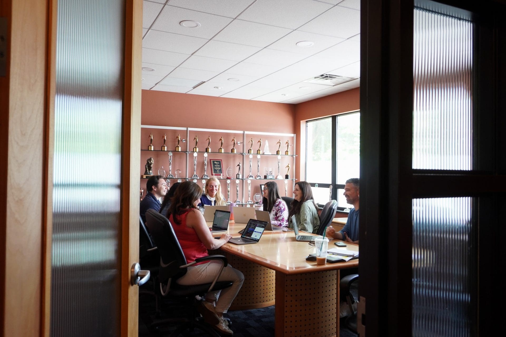EGC colleagues gathered around a conference table with laptops