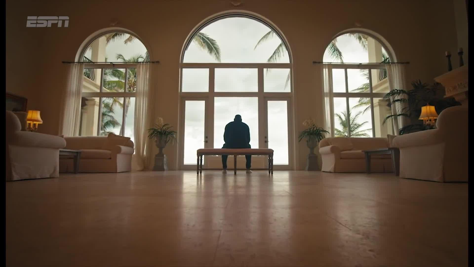 ESPN House of ’98 campaign still showing a seated silhouette beneath three tall arched windows