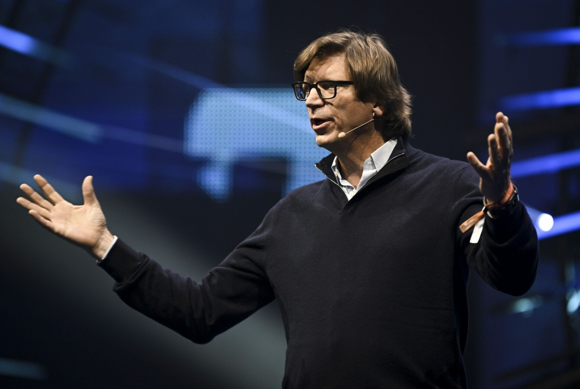 Niklas Zennström speaking on stage, gesturing with both hands