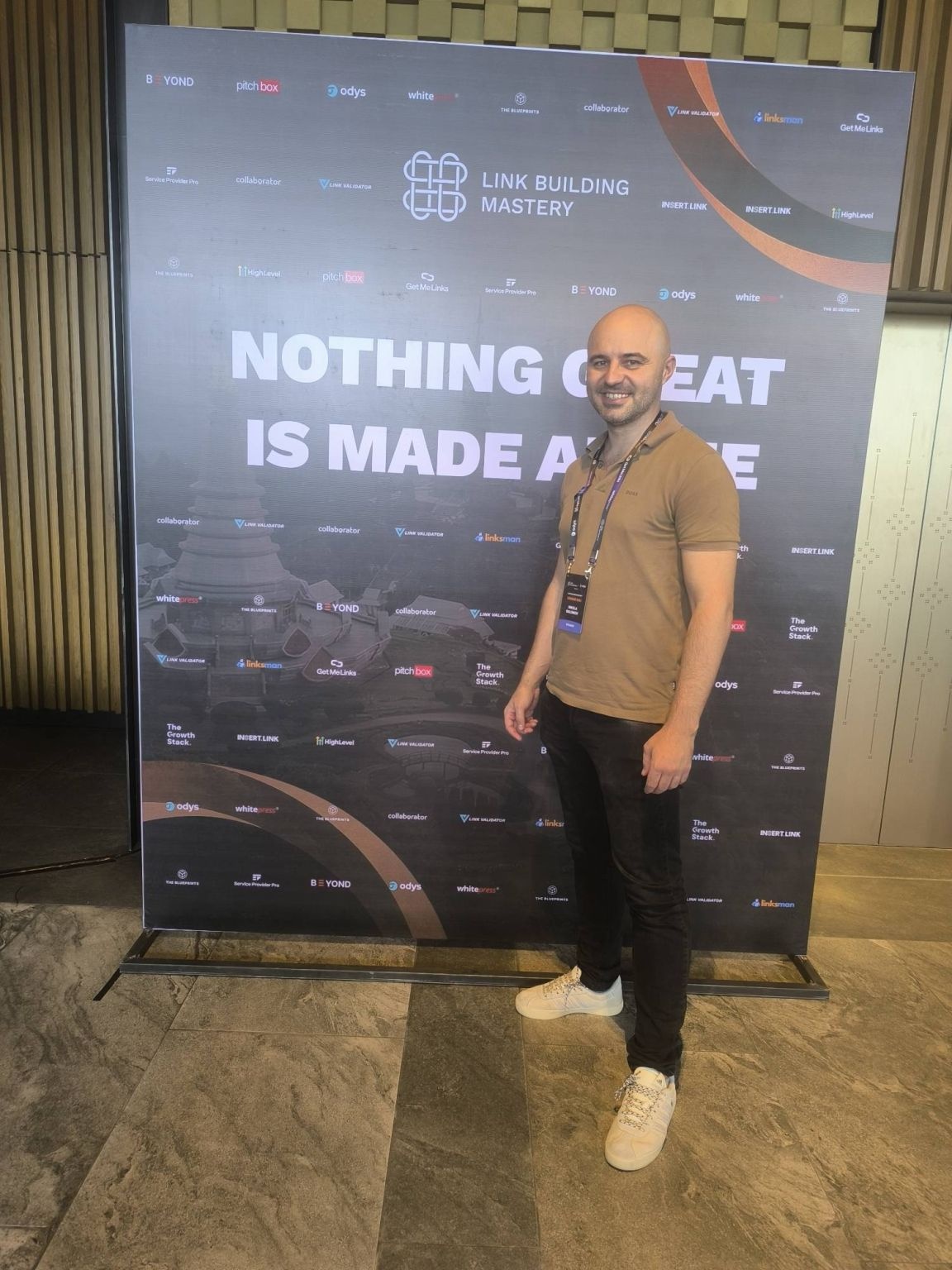 Nikola Baldikov beside the Link Building Mastery event backdrop